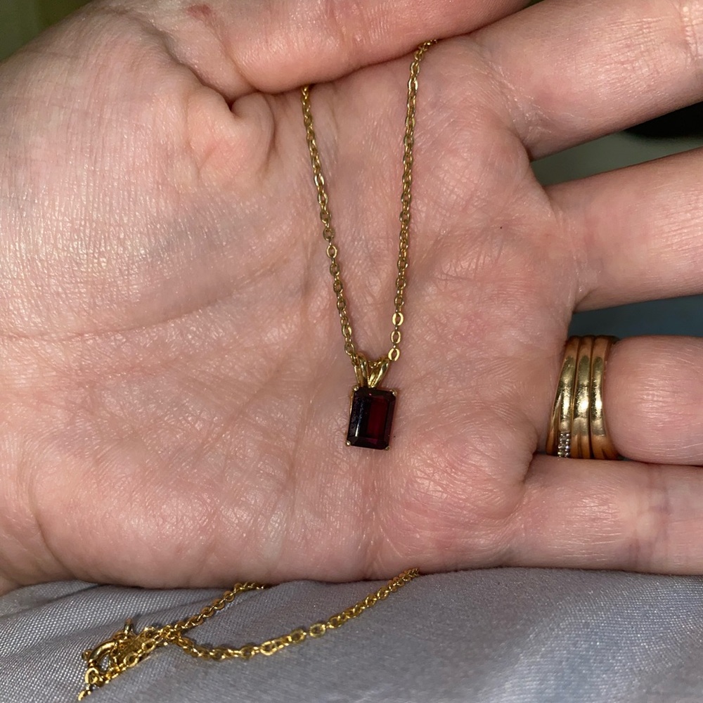 Red gem and gold colored chain